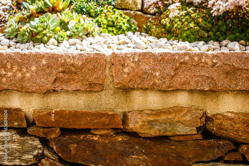 brick wall with flowers on top