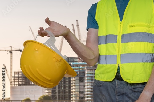 Worker with protective helmet on construction site.