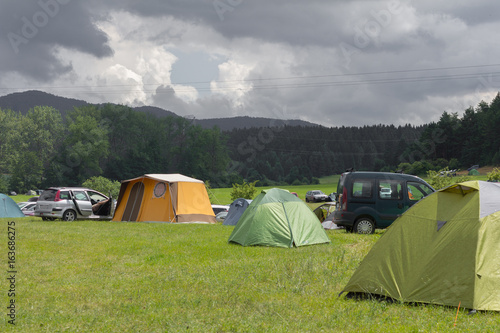camping tents on the green summer meadow