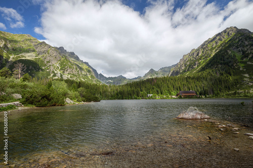 The landscape of the picturesque lake Popradske pond surrounded by mountain peaks.