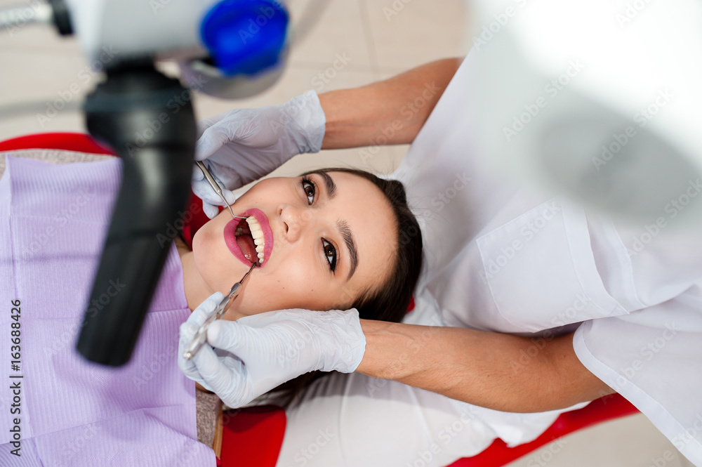 Beautiful girl treats teeth in dentistry. Beautiful girl treats teeth in dentistry.