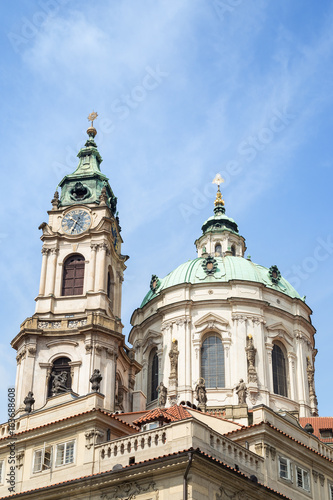 View of tower and dome of Church of Saint Nicholas (St. Nicholas Church) in Mala Strana or Lesser Town in Prague, Czech Republic, in the daytime. © tuomaslehtinen