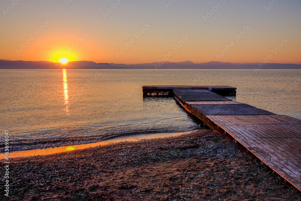 Sunrise on the sea in Moraitika, Greece.