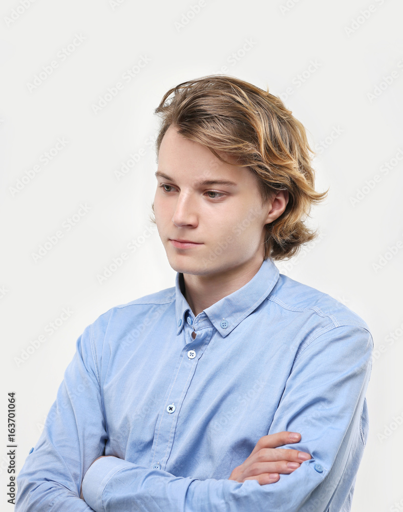 Attractive teenage boy,gray background Attractive teenage boy,gray background