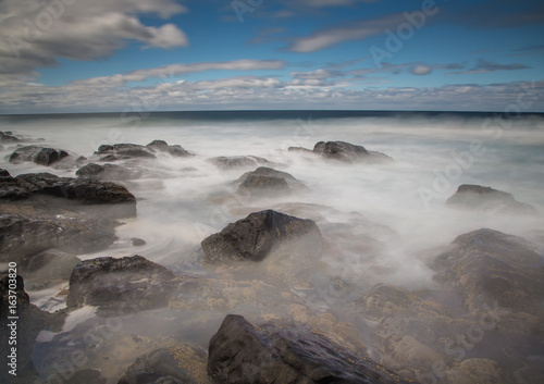 Long time exposure of waves around rocks at the Wild Coast at the Indian Ocean in South Africa