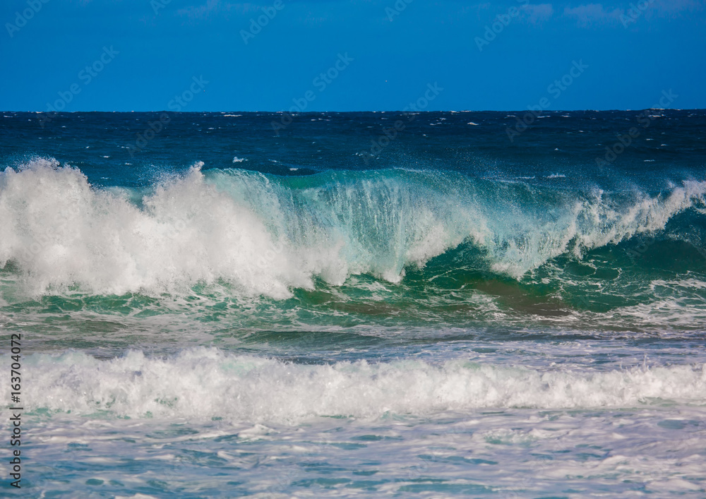 Breaking waves of the Indian Ocean at the Wild Coast of South Africa with cloudy sky Breaking waves of the Indian Ocean at the Wild Coast of South Africa with cloudy sky