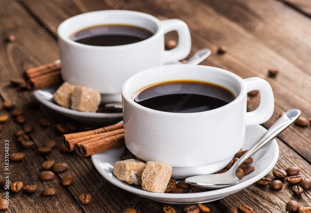 Two cups of espresso on brown napkin Two cups of espresso on brown napkin