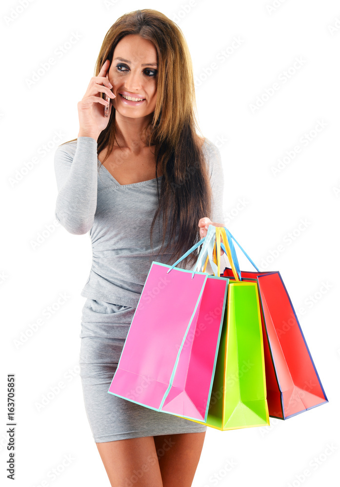 Young woman with shopping bags isolated on white Young woman with shopping bags isolated on white