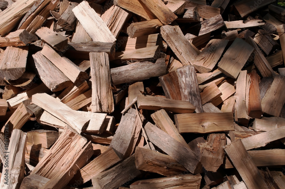 A large pile of cut wood before being stacked A large pile of cut wood before being stacked