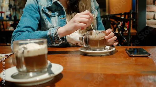 Wallpaper Mural Pretty girl in a cotton jacket with a hot chocolate in a cafe. Vintage interior. Brick wall. Torontodigital.ca