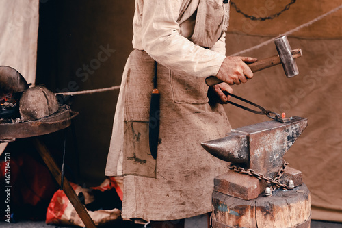 Blacksmiths work as forging forging on metal. The concept of making products from iron.
