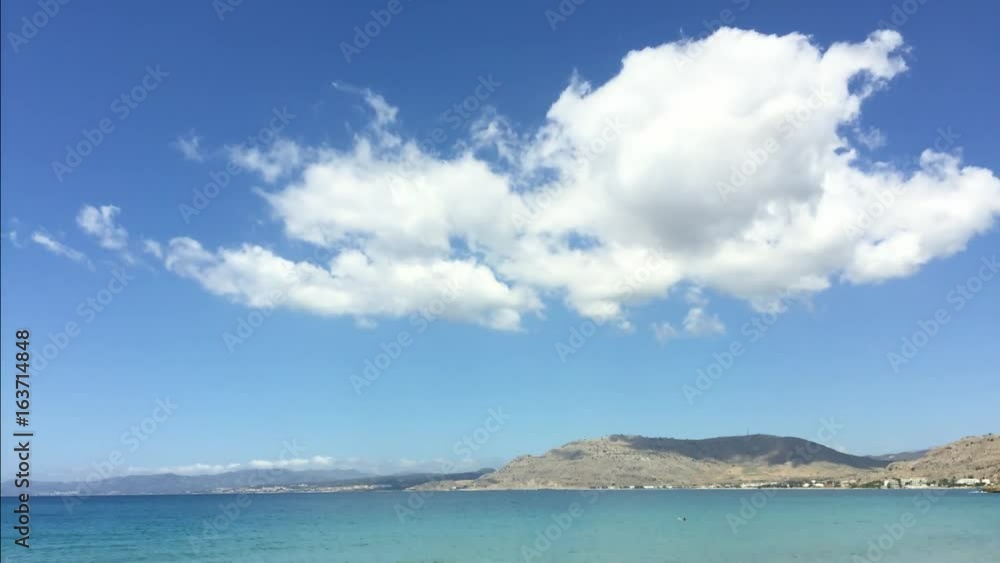 Time-lapse video of tropical clouds on blue sky with azure blue sea below. Island of Rhodes, Greece Time-lapse video of tropical clouds on blue sky with azure blue sea below. Island of Rhodes, Greece