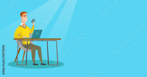 Young caucasian man paying online by credit card.