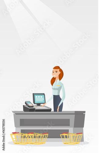 Cashier standing at the checkout in a supermarket.