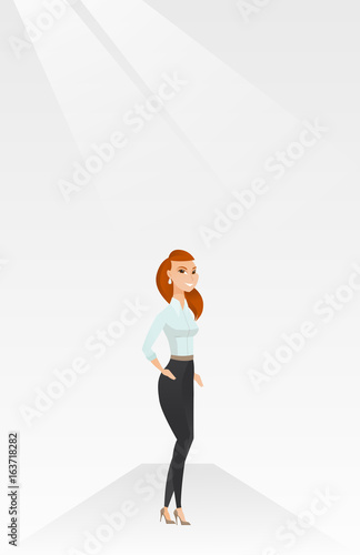 Woman posing on catwalk during fashion show.