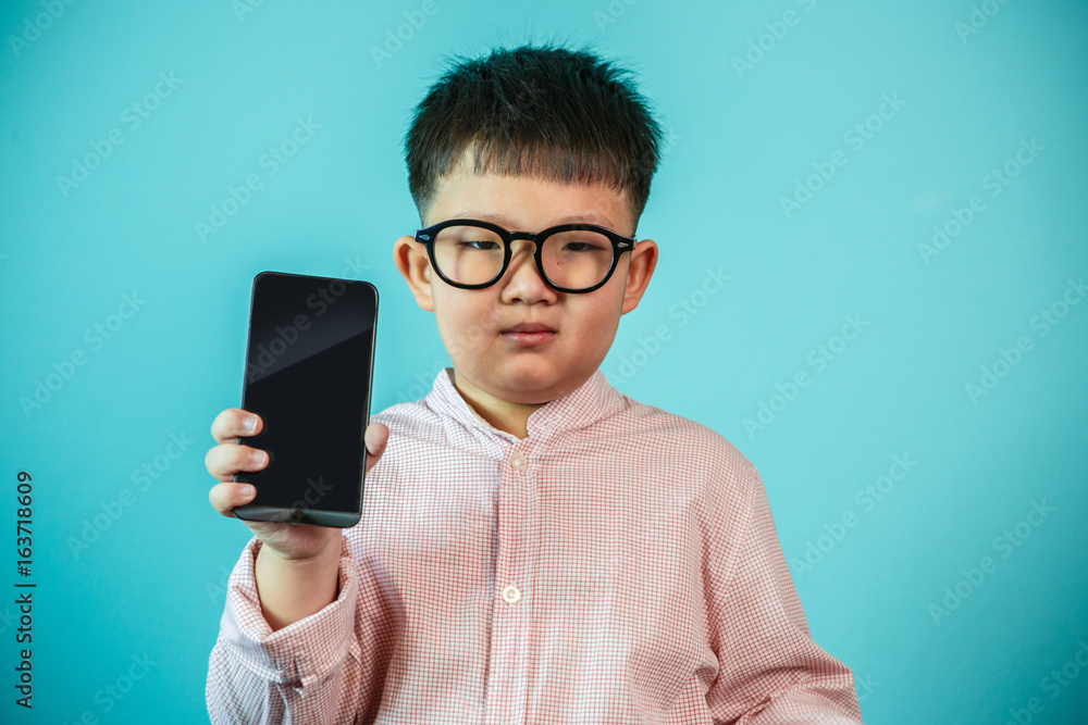 Asian boy with smartphone at home playing