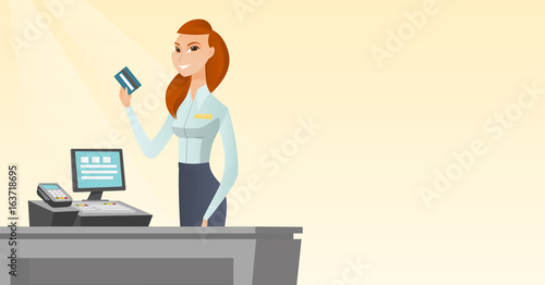 Caucasian cashier holding a credit card.