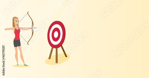 Sportswoman aiming with a bow and arrow at target.