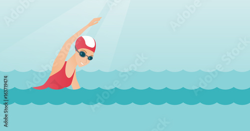 Young caucasian sportswoman swimming.