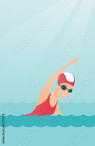 Young caucasian sportswoman swimming.