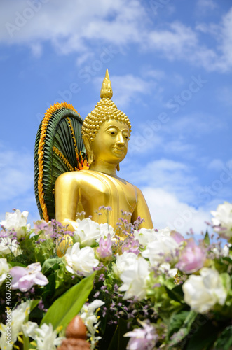 Buddha statue on bright sky background. photo