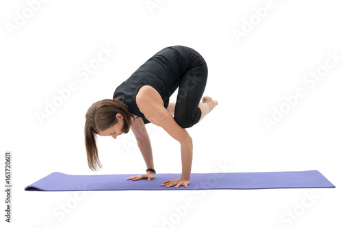 Woman doing handstand in studio isolated shot