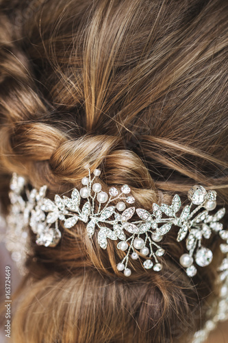Hairpin in the bride's hair, wedding hairstyle with accessories with jewelery