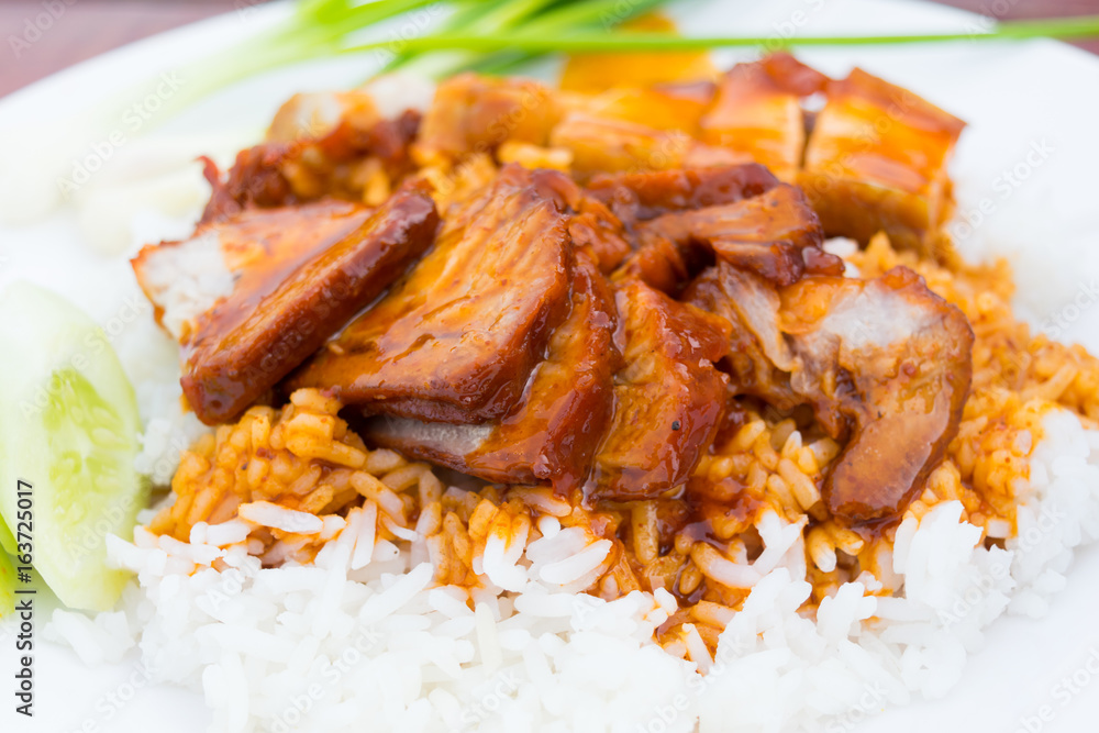 Barbecued red pork in sauce with rice on the table
Barbecued red pork in sauce with rice on the table
