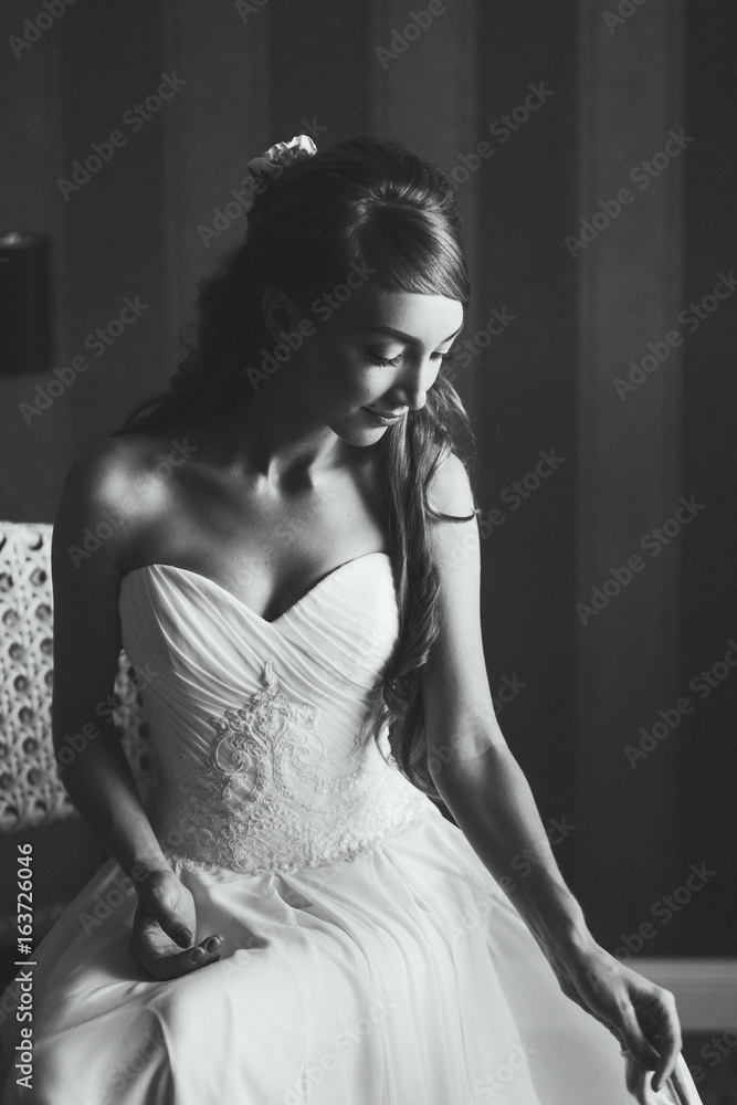 Fototapeta premium Beautiful black and white portrait of young woman in wedding dress