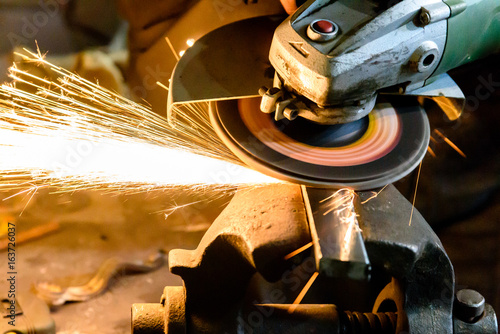 Cutting metal grinding machine, spark. photo