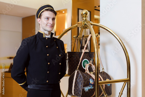 Tapeta Young man in uniform serving in hotel