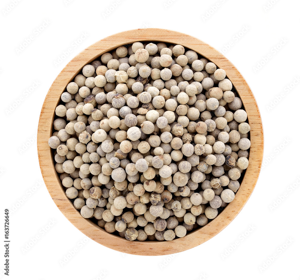 white peppers in wooden bowl on white background white peppers in wooden bowl on white background