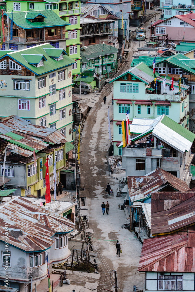 Fototapeta premium Colorful mountain's village in the afternoon with people on the street in winter at Lachen in North Sikkim, India.