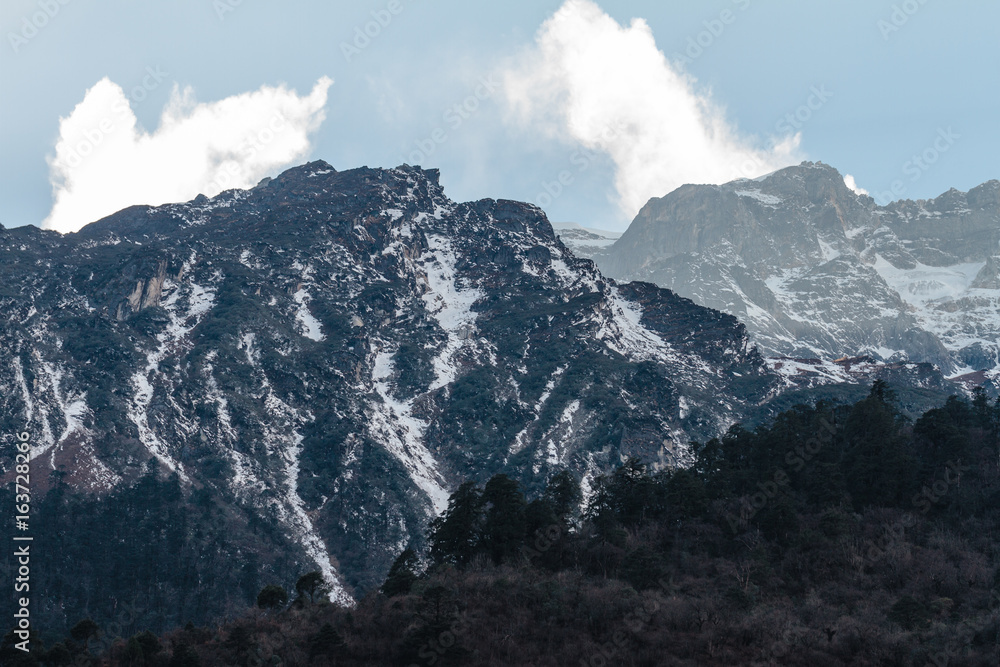 Mountain with little snow and cloud on the top sunlight in the morning in winter at Lachen in North Sikkim, India.