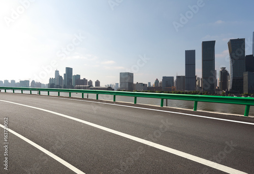 Empty road surface floor with city landmark buildings of Shanghai Skyline