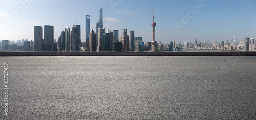 Empty road surface floor with city landmark buildings of panorama