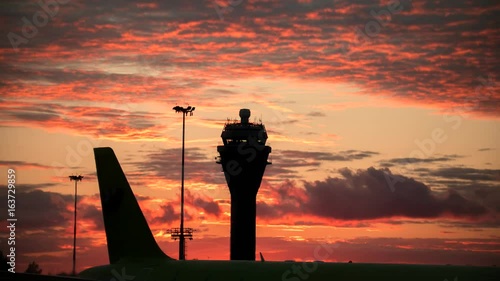 Timelapse view of International airport at sunset - control tower