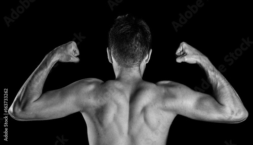 Fényképezés Male bodybuilder flexing his biceps, back view