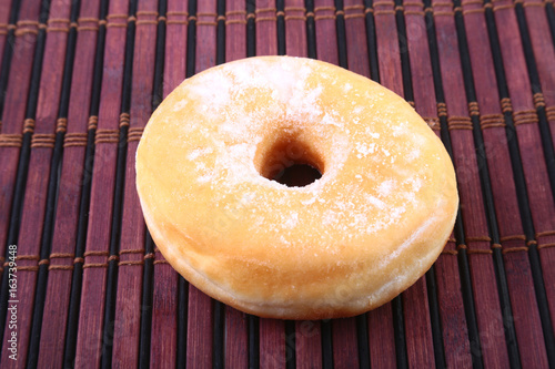 Homemade Doughnuts with Jelly filled and powdered sugar on Bamboo tablecloth. Selective focus. photo