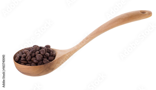 roasted black coffee beans in wooden spoon isolated on a white background