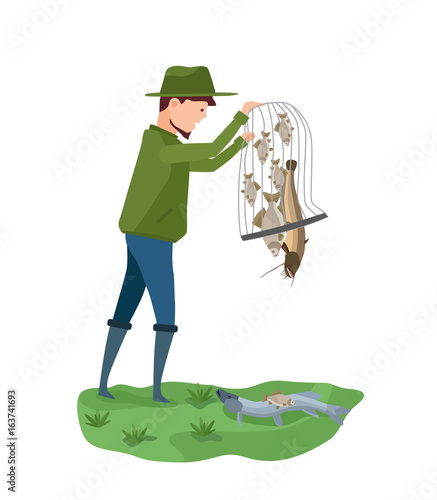 Fisherman on bank of river, puts fish on the ground.