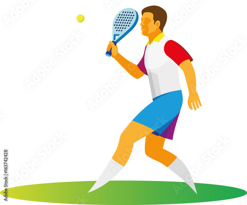 A young man plays on the court in a padel tennis