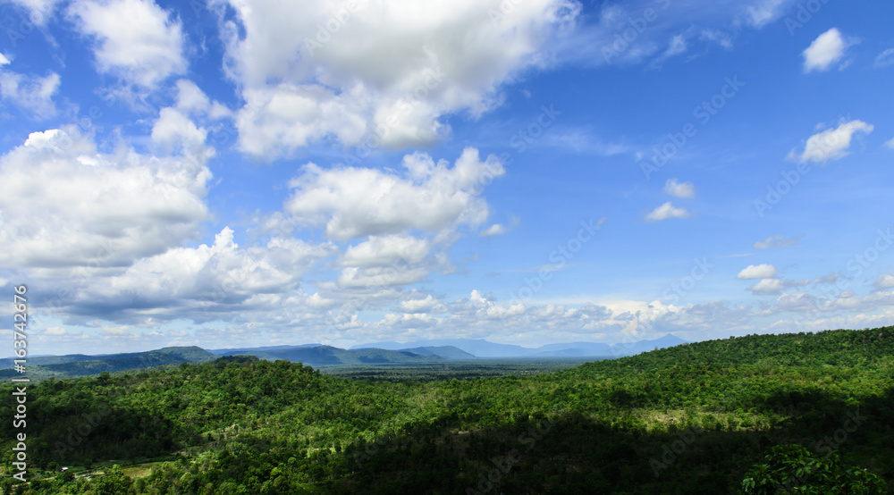 Blue sky with white clouds. Top view from mountain see the forest below and  Cloudy sky background. Photos | Adobe Stock