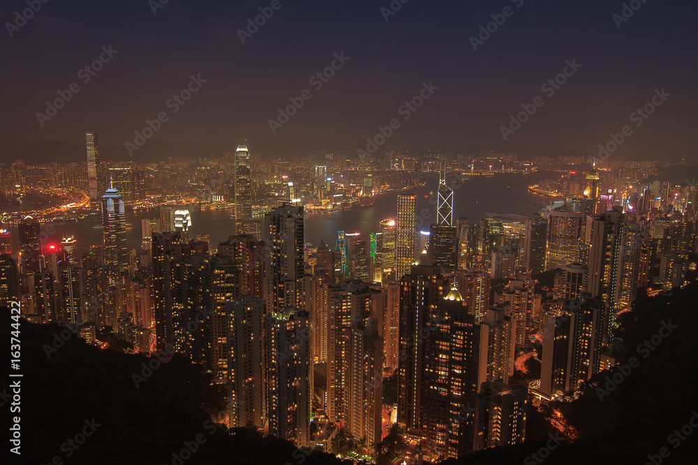 Evening aerial view panorama of Hong Kong skyline and Victoria Harbor. Travel destinations.