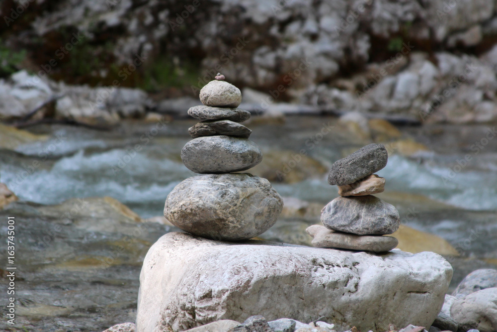a pyramid of stones near the mountain river a pyramid of stones near the mountain river