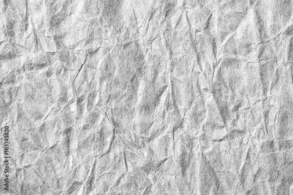 Fototapeta premium Colorless creased paper background texture