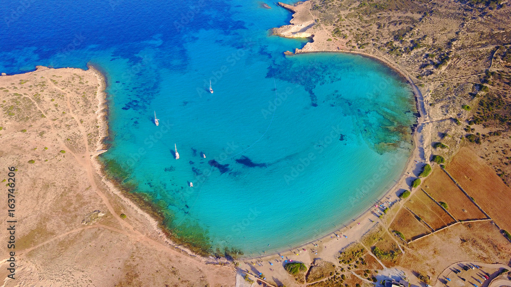 Obraz premium Aerial drone photo of famous caves of Ksylobatis near Pori beach, Koufonissi island. Cyclades, Greece
