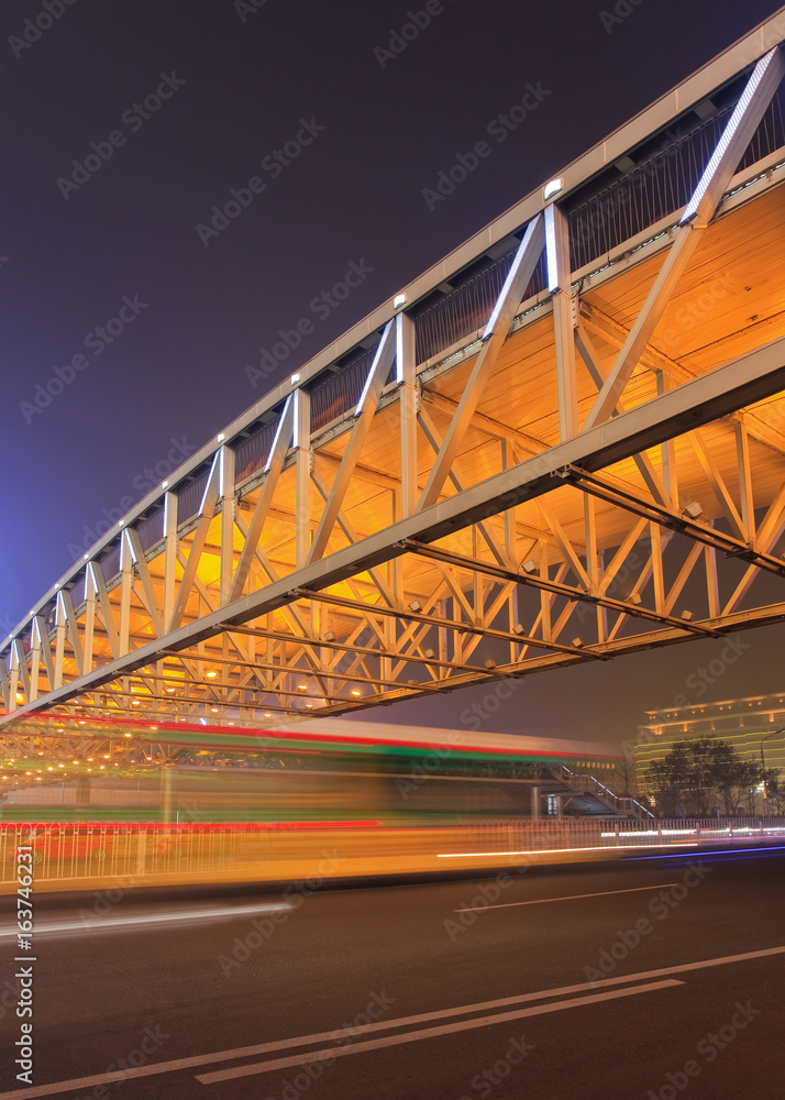 Pedestrian bridge with traffic in motion blur at night, Beijing center, China