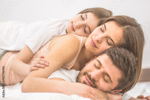 The happy family sleeping on the bed © realstock1