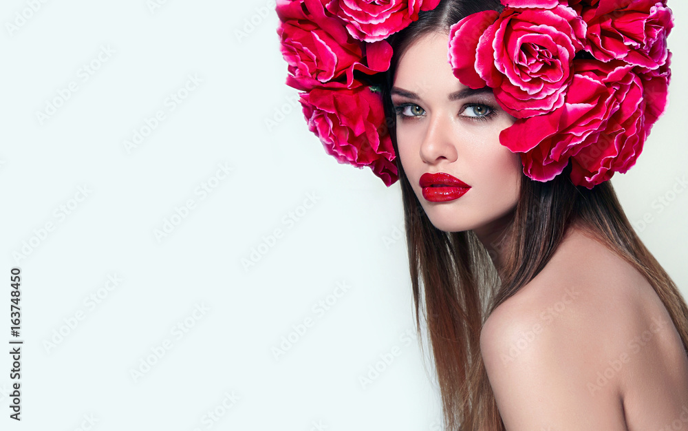 Beautiful young girl with a lavish wreath of red roses on her head. Close-up portrait in studio on white background. Long straight hair, bright makeup - red lips,dark eyes. Fashion,beauty,advertising. Stock Photo | Beautiful young girl with a lavish wreath of red roses on her head. Close-up portrait in studio on white background. Long straight hair, bright makeup - red lips,dark eyes. Fashion,beauty,advertising. Stock Photo |